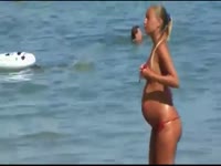 Hot and gorgeous pregnant exposing her sexy body and big belly on the beach
